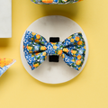 Cocopup London Amalfi Lemon Bow Tie with blue, orange, and yellow floral pattern on a white background.