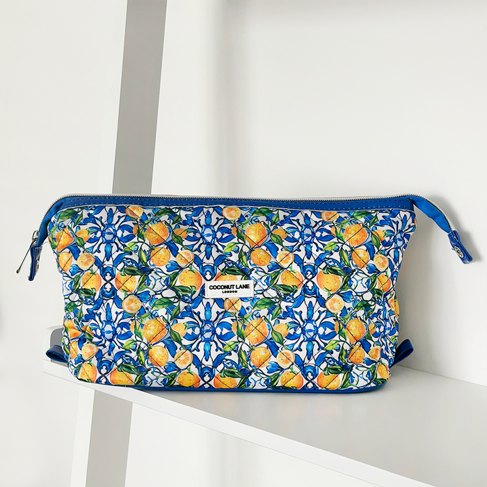Blue makeup bag with a floral print, labeled The Amalfi Lemon Expandable by Cocopup London.