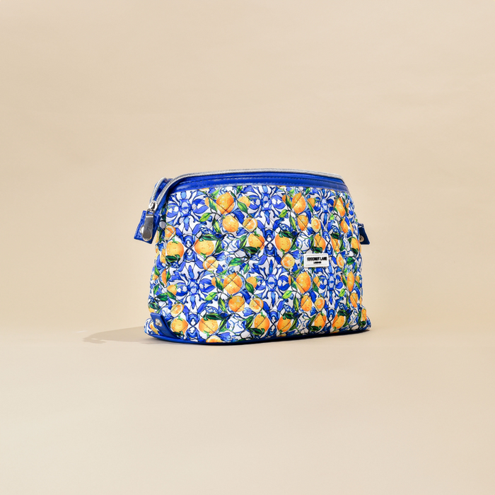 Expandable makeup bag with bright lemon and floral print on neutral beige fabric by Cocopup London.