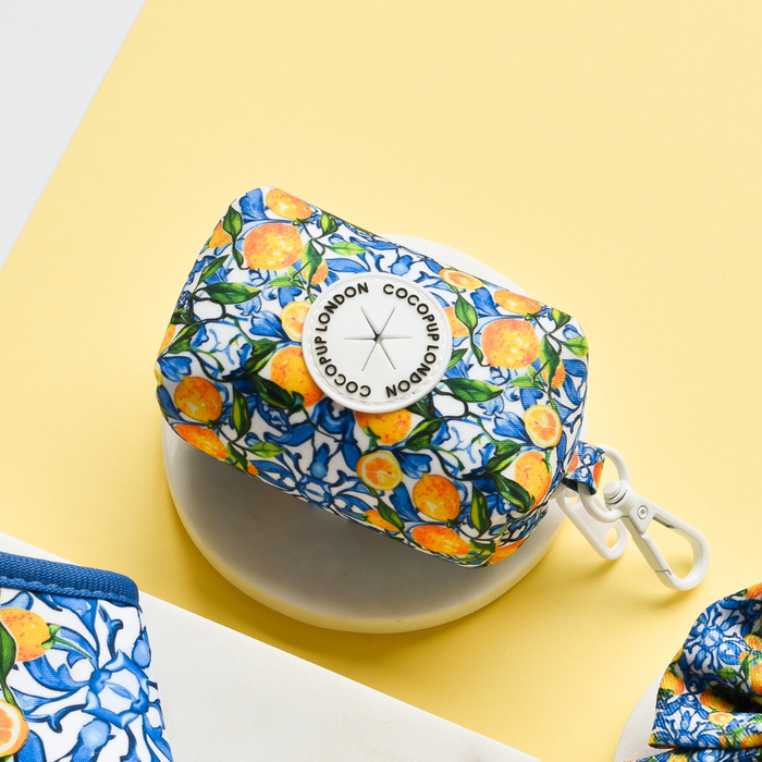 Yellow lemon-patterned poop bag holder with white clip from Cocopup London.