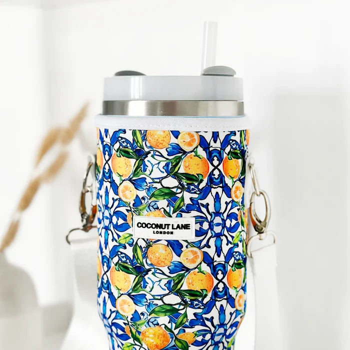 Cocopup London tumbler carry case with a lemon and blue floral pattern and a white strap.