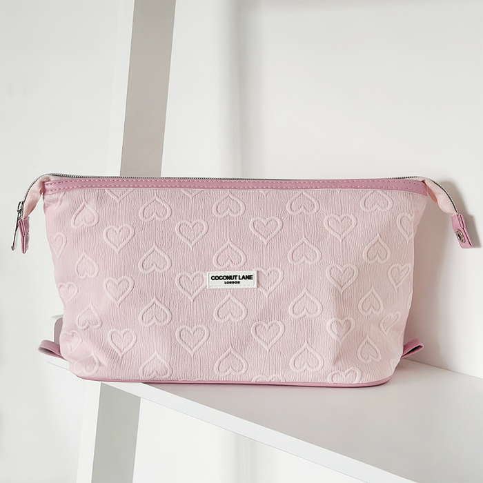Light pink expandable makeup bag with heart pattern and Cocopup London branding.