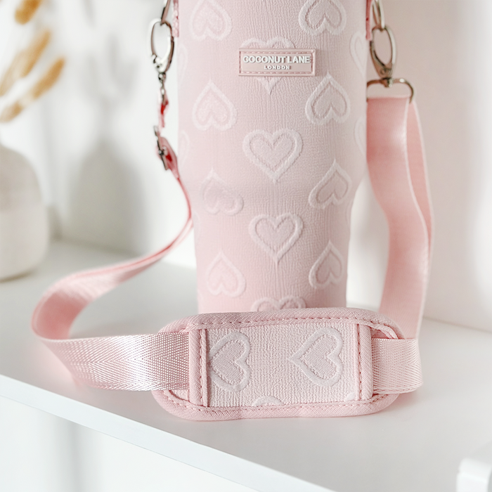 Baby pink tumbler carry case with heart pattern and cross-body strap, Coconut Lane x Cocopup London.