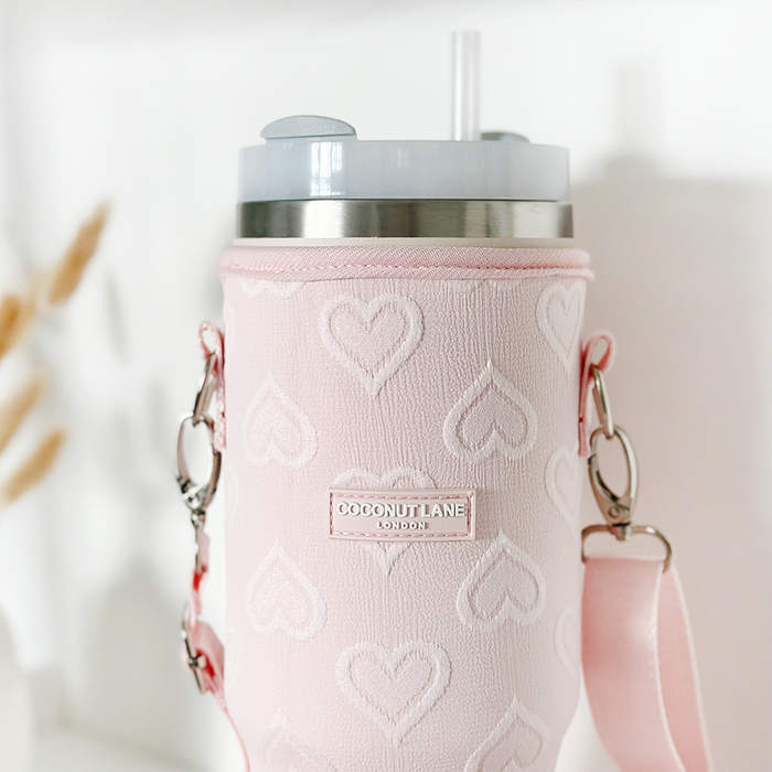 Baby pink tumbler carry case with white heart pattern, made by Cocopup London.