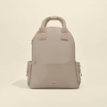 Caramel Latte Cocopup London rucksack with soft top handles and a front zip pocket.