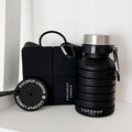 Black Cocopup London bundle with a square lunchbox and round collapsible water bottle featuring a metal carabiner.
