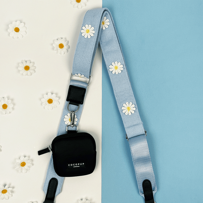 Blue Bag Strap with white flower decals.