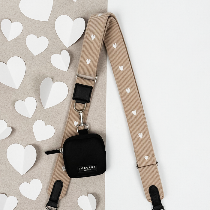 Chai Hearts Cocopup London bag strap with small black pouch, displayed on a white heart-shaped cut-out background.