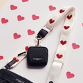 Cocopup London bag strap with red hearts and heart cutouts on a knitted material.