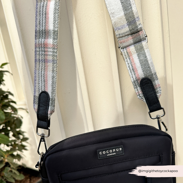 Cocopup London dog walking bag with Oxford Plaid strap hanging on a cream fence.
