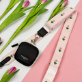 Pink Bag Strap with tulip embroidery design, attached to this is a black Cocopup Treat Pouch.