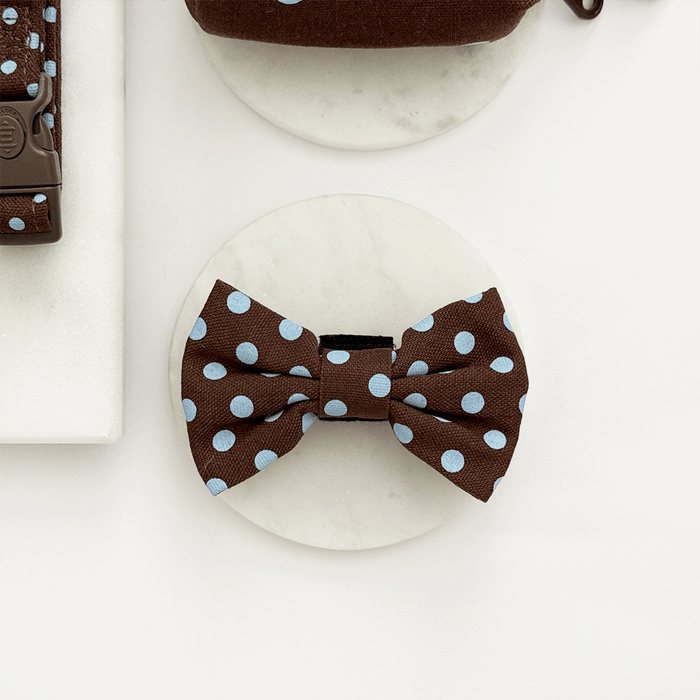 A brown dog bow tie with light blue polka dot design. With velcro fastening.