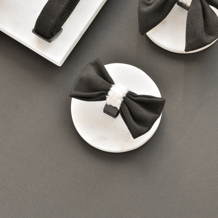 Black Cocopup London Aviator Bow Tie with a white center, displayed on marble against a gray background.