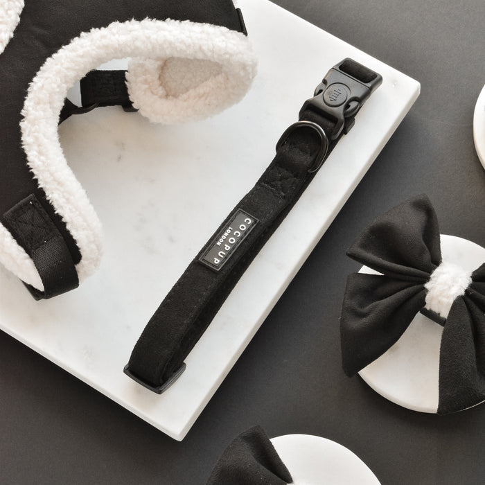 Black Aviator collar and bow ties by Cocopup London displayed on a marble and dark surface.