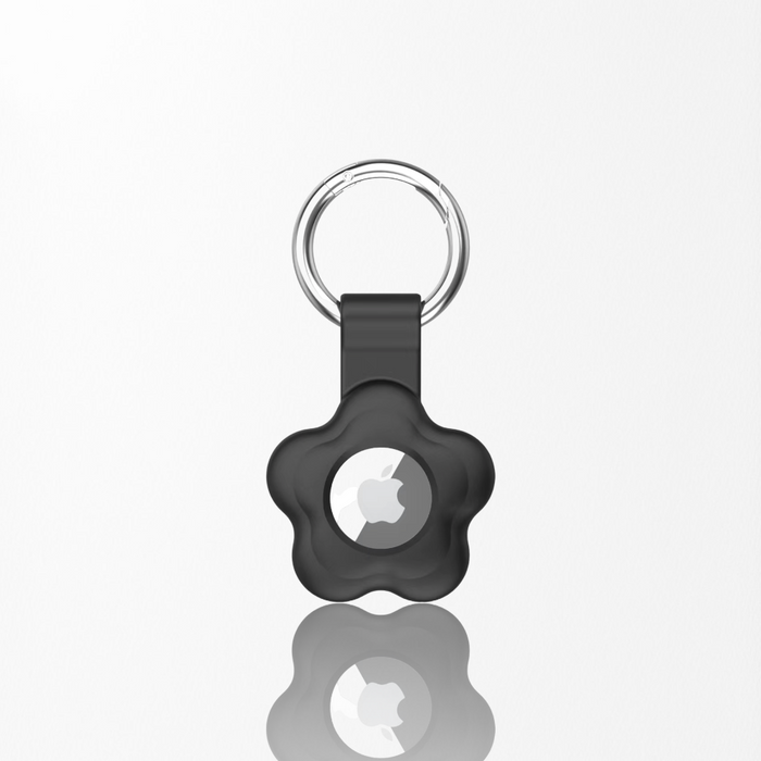 Black silicone AirTag case with a flower design from Cocopup London, shown with AirTag inside on a white background.