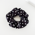 Black scrunchie with white polka dots.