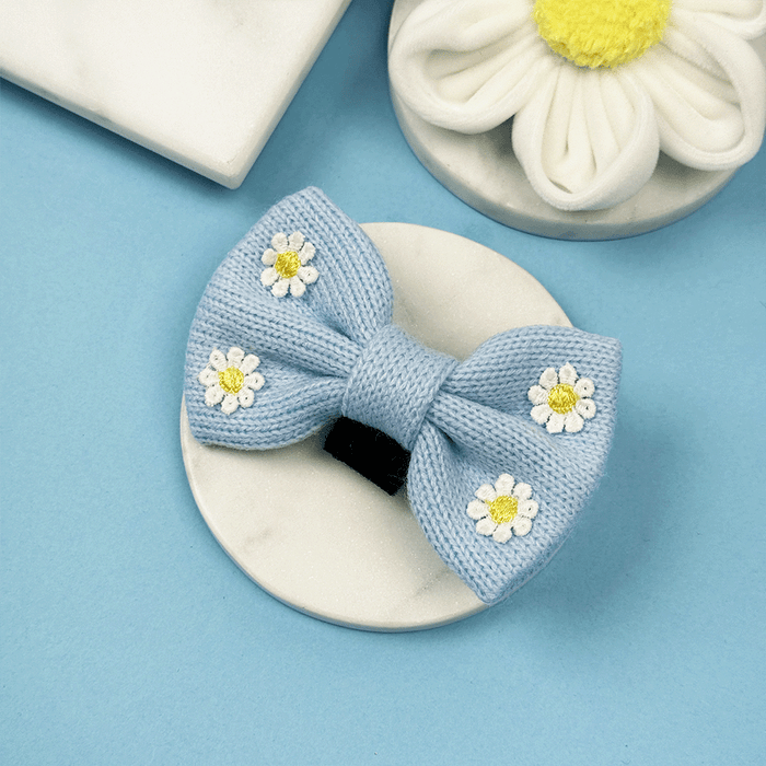Blue dog Bow Tie with white flower decals.