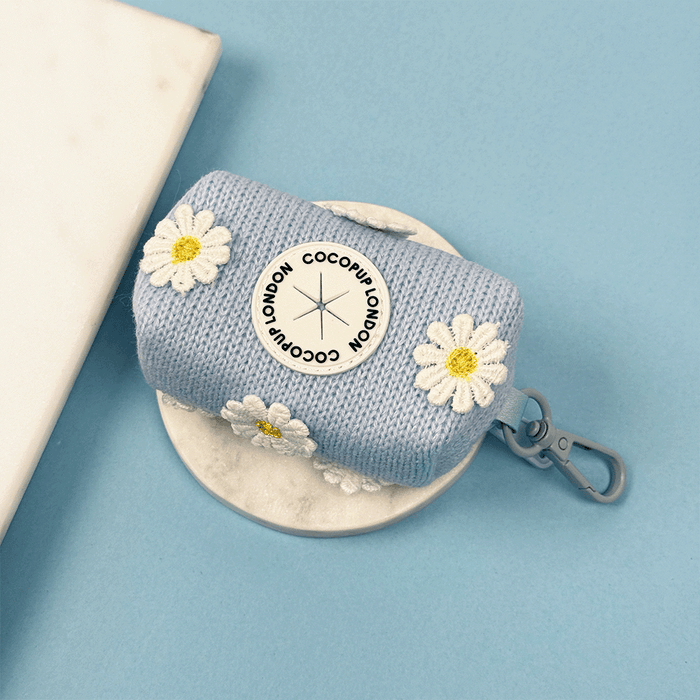 Blue dog Poop Bag Holder with white flower decals.