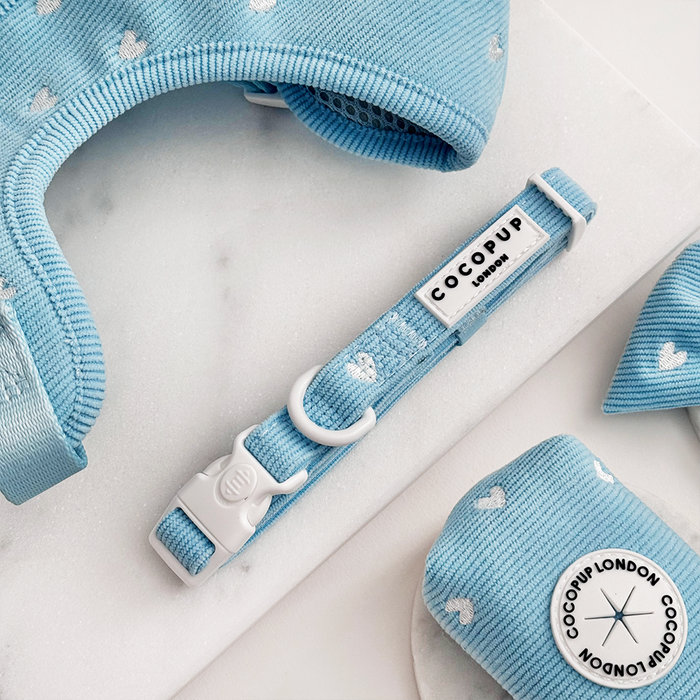Blue cord pet collar with white heart pattern by Cocopup London, displayed on a white surface.