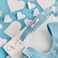Blue Heartstrings cord dog lead by Cocopup London on a white surface with blue background and scattered paper hearts.