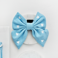 Blue corduroy sailor bow tie for dogs with white heart pattern.