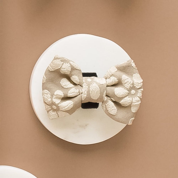 Beige floral Cocopup London Luxe Bow Tie for dogs, displayed on a plain white background.