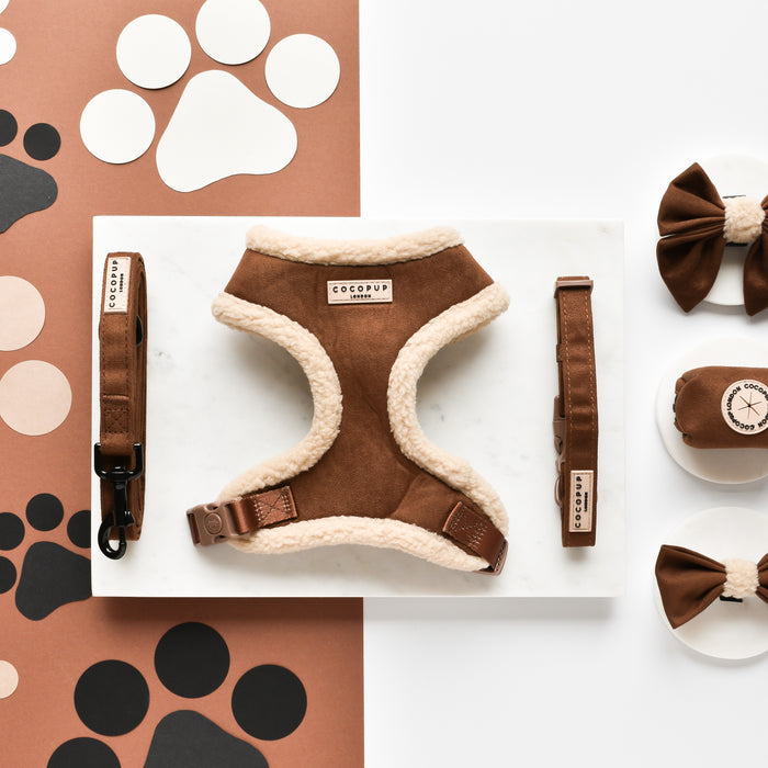 Brown faux suede dog collar with fluffy trim, matching bow tie, and attached waste bag holder.