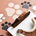 Brown faux suede dog leash with black and beige paw prints, designed for small breeds.