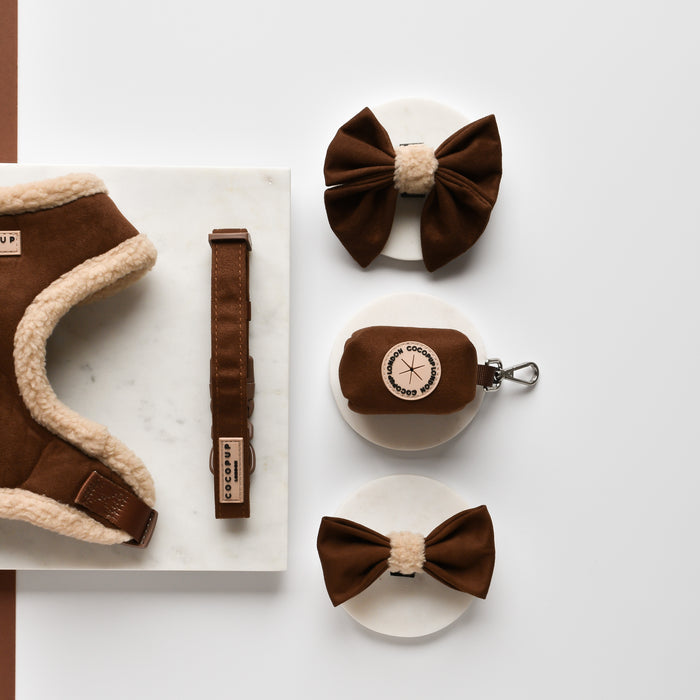 Brown faux suede Cocopup London poop bag holder with gold zipper, shown on a white background.