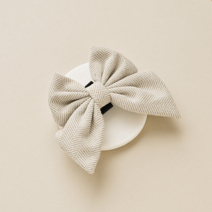Brown tweed sailor bow tie with a white herringbone pattern and black center detail.