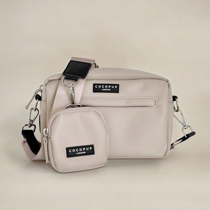 Caramel-colored dog walking bag and matching treat pouch, both labeled Cocopup London, on a plain background.