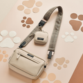 Large caramel latte dog walking bag with matching pouch and plaid strap, displayed on a paw print background.
