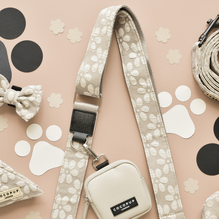 Large caramel latte dog walking bag with matching treat pouch and poop bag dispenser, displayed on a peach background.