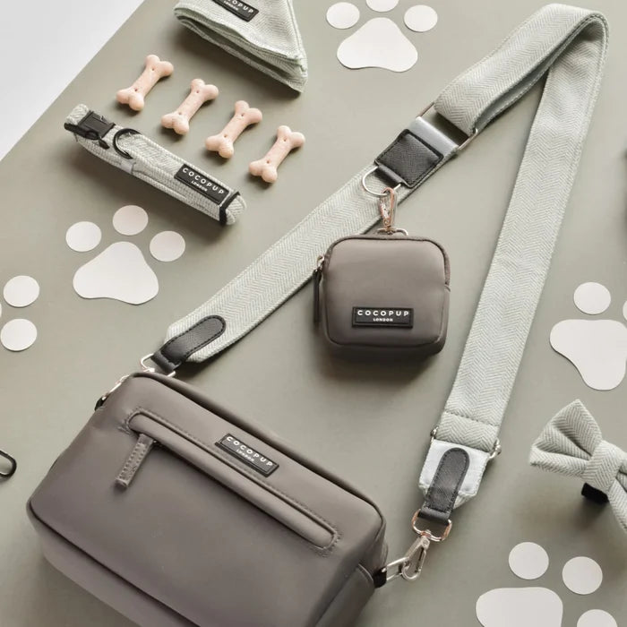 Mocha dog walking bag with matching grey collar, leash, bow, and treat pouch arranged neatly on a flat surface.