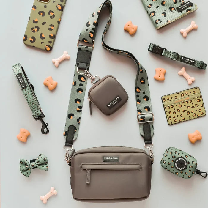 Mocha brown dog walking bag set with matching leash, bow tie, treat pouch, and poop bag holder on flat surface.