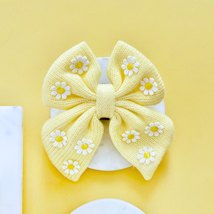 Yellow sailor bow tie with white and yellow daisy pattern from Cocopup London.