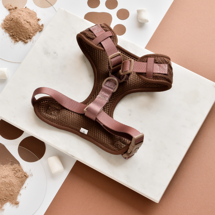 Brown cable knit harness, lead and collar set by Cocopup London on a white marble surface.