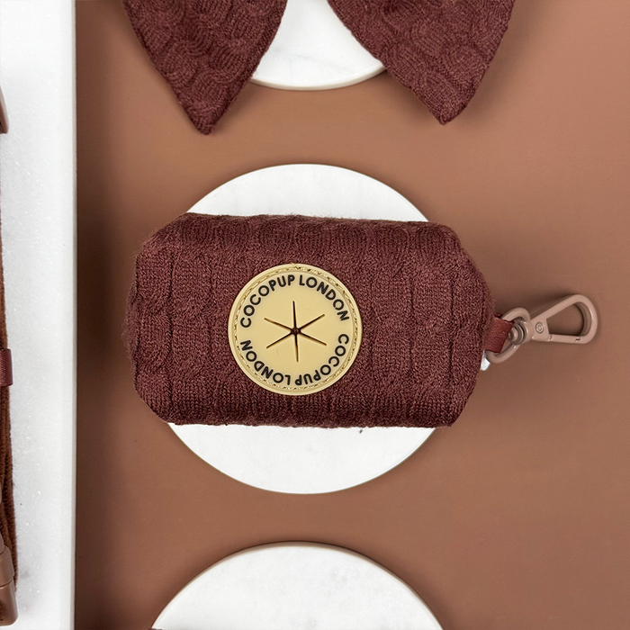 Brown cable knit poop bag holder with clip, labeled The Cocopup London.