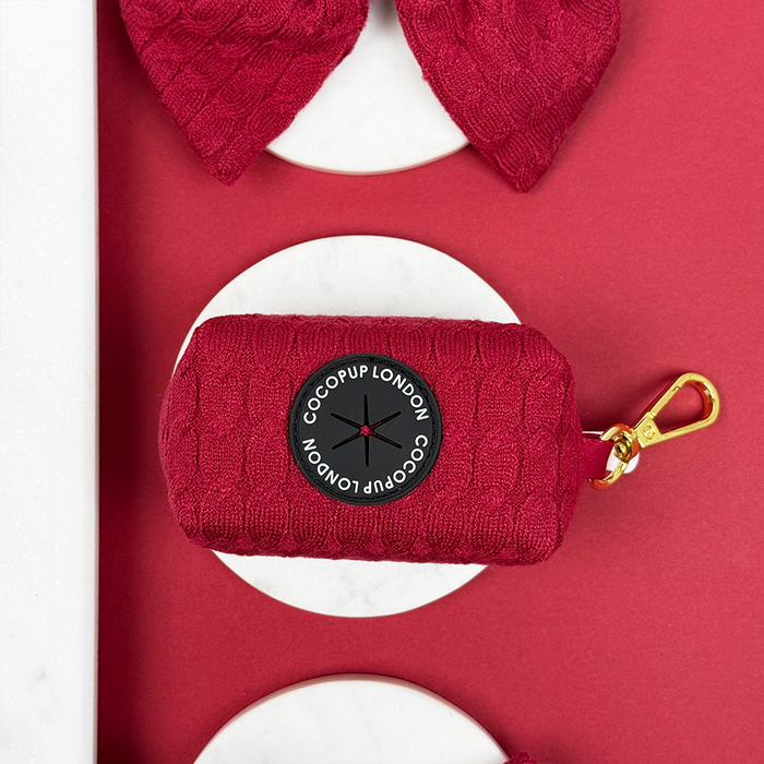 Mulled wine cable knit poop bag holder with gold clip and Cocopup London label.