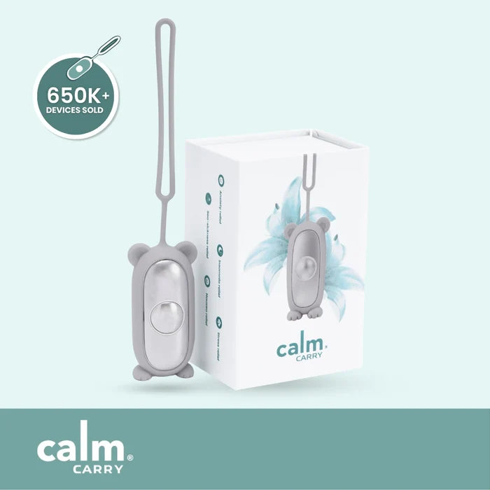 Grey CalmCarry device with packaging on a light blue background