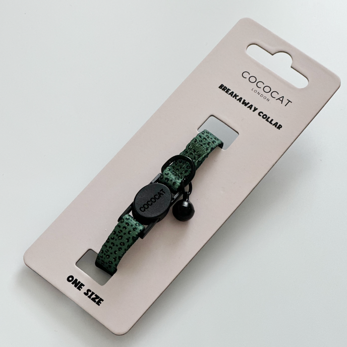 Khaki leopard print cat collar with black breakaway buckle and bell on Cocopup London Breakaway Collar packaging.