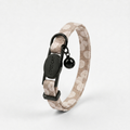 Mocha Flower-patterned cat collar with breakaway buckle, gold COCOCAT tag, and black bell.