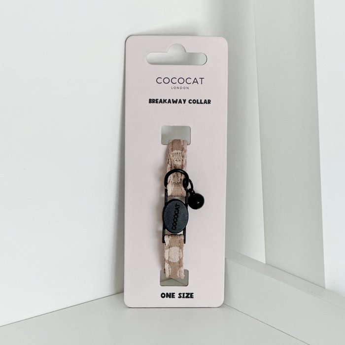 Mocha flower-patterned Cocopup London cat collar with a bell and breakaway buckle on a white background.