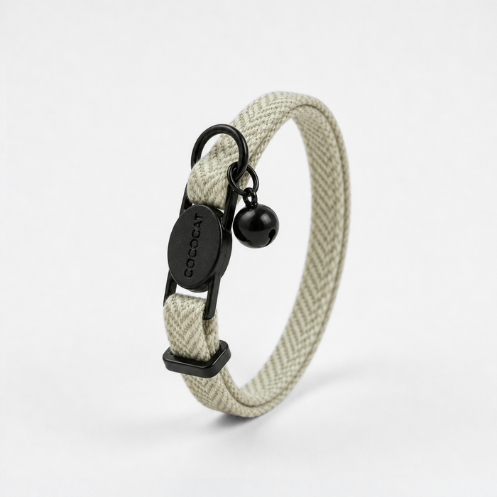 Sage tweed cat collar with breakaway buckle, black ring, and bell shown on a white background.