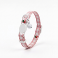 Pink checkered cat collar with strawberry print, breakaway buckle, and bell on a white background.