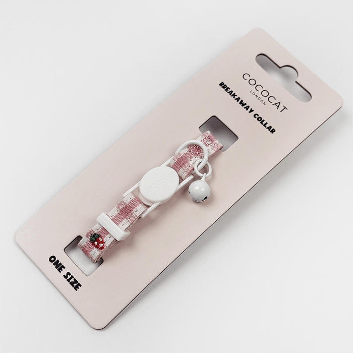 Pink gingham cat collar with breakaway buckle, small bell, and a strawberry-shaped charm.