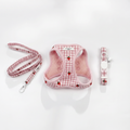 Cat harness, lead, and collar set in pink checkered pattern with red strawberries on white background.