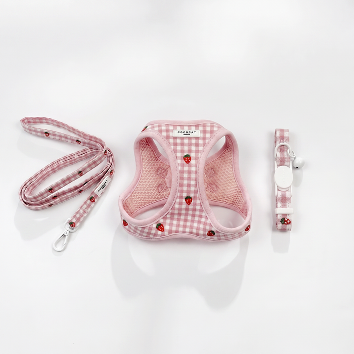 Cat harness, lead, and collar set in pink checkered pattern with red strawberries on white background.