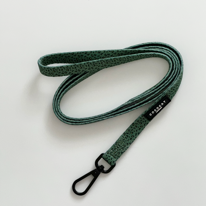 Khaki leopard print cat lead by Cocopup London with black metal clip and label on a white background.