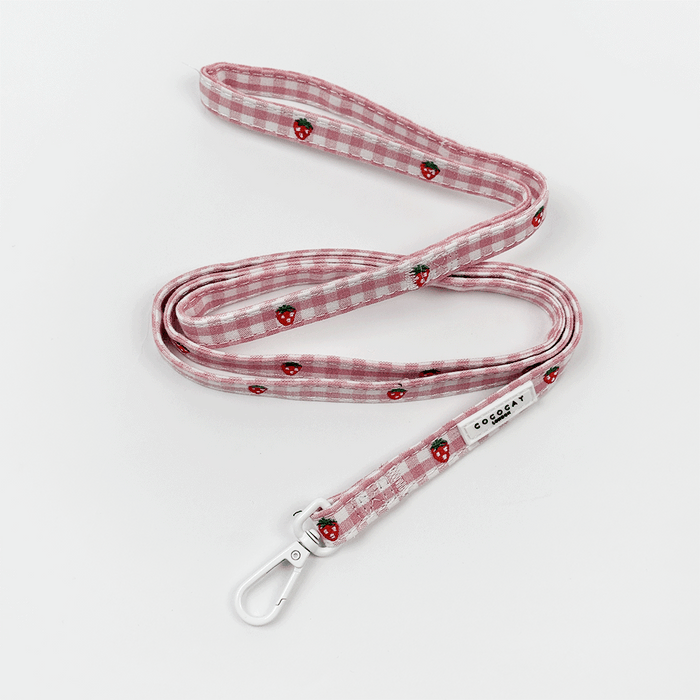 Pink cat lead with a strawberry pattern and gold hardware from Cocopup London.